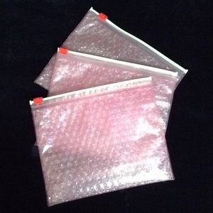 Set of Glossier makeup bags!